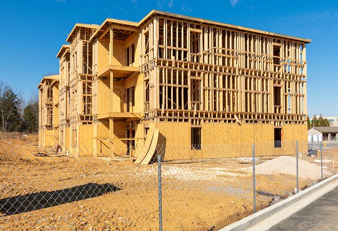 a temporary chain link fence locking away a building under renovation, serving as a security tool in Seal Beach